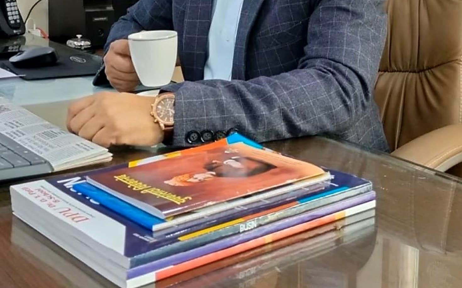 Books and a cup of coffee on Dr. Amol Gawande’s desk
